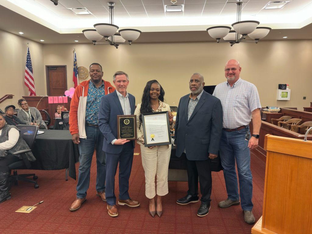 Retiring County Administrator Rayetta Volley Poses with Commissioners. Photo Credit Nigel Poole.